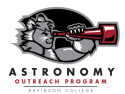 A wildcat looking through a telescope. Astronomy Outreach Program Davidson College logo