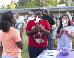 Students blowing pinwheels