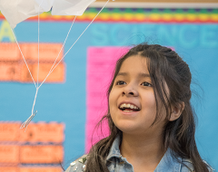 Student watching a parachute